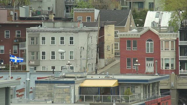 Urban housing in Quebec City, Quebec, Canada on an overcast afternoon. Quebec provincial flag.