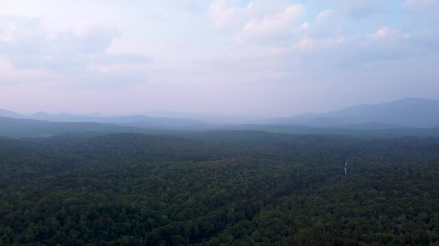 Maidstone, Vermont, an aerial view of the dense northern forest and rolling green mountains of the Northeast Kingdom after sunset.