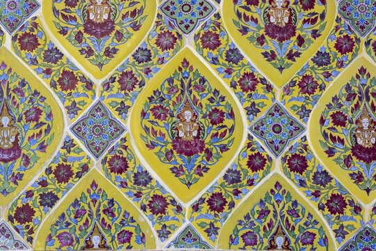 Coloured Bencharong ceramic tiles, depiction of Thai angels (devas) in diamond-shaped frames, circular gallery (Phra Rabieng) around the central chedi, Wat Ratchabophit (full name Wat Ratchabophit Sathit-Mahasimaram Ratcha Wora Maha Viharn), Buddhist temple, Wat, Phra Nakhon district, Bangkok, Thailand