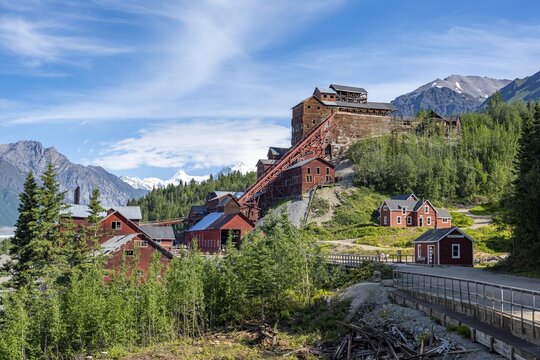 Red Kennicott buildings in front of mountainous landscape, Kennicott Concentration Mill to extract copper from quarried rock, Historic Kennecott Copper Mine, National Historic Landmark, Wrangell St. Elias National Park, Alaska, USA