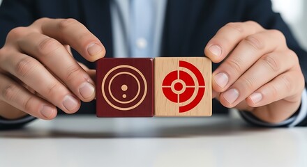 Businessman holding wooden blocks with target and bullseye symbols