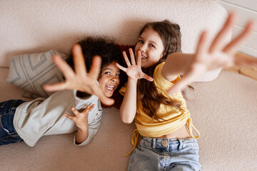 Diverse children smiling, reaching hands,