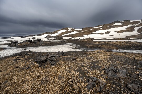 Snow-covered volcanic landscape with tuff and petrified lava, crater of Askja volcano, Icelandic highlands, Iceland