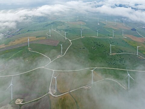 Windmills on a wind farm near Zahara de los Atunes, at a cloudy morning, aerial view, drone shot, C&aacute;diz province, Andalusia, Spain