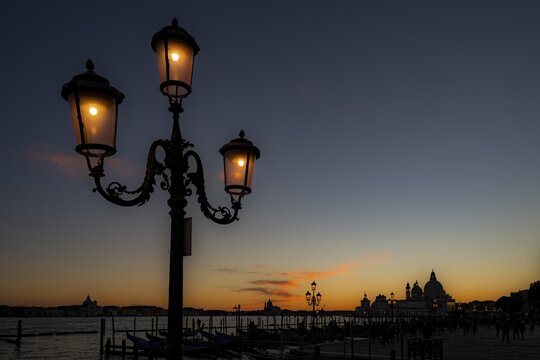 Illuminated lantern at blue hour, Church of Santa Maria della Salute in the background, Venice, Veneto, Italy