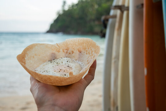 Egg hopper Sri Lankan street food at tropical beach