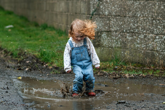 The joy of a child jumping in a puddle in rural Ireland