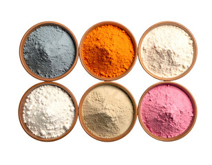Overhead shot of six small, brown bowls filled with vibrantly colored powdered substances