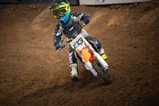 Latvia, Riga August 27, 2025,  regular training Young motocross rider navigating tight turn on dirt track