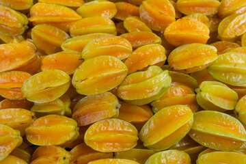 close up on fresh starfruit carambola stacking in the market