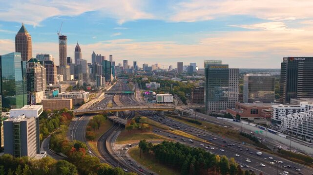 Futuristic aerial view of Atlanta city landscape with skyscrapers and layered road networks, overpasses and busy highway traffic forming a vital transportation artery.