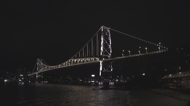 Florianopolis, night view of the Herc&iacute;lio Luz suspension bridge with the Santana fort in the foreground.