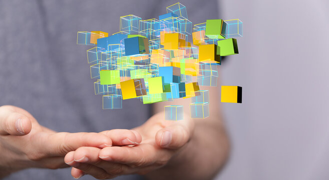 Hand holding colorful digital cubes representing data, technology, and connection. Concept of innovation and virtual rea
