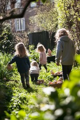 Fototapeta premium Children participating in an Easter egg hunt in a sunny garden