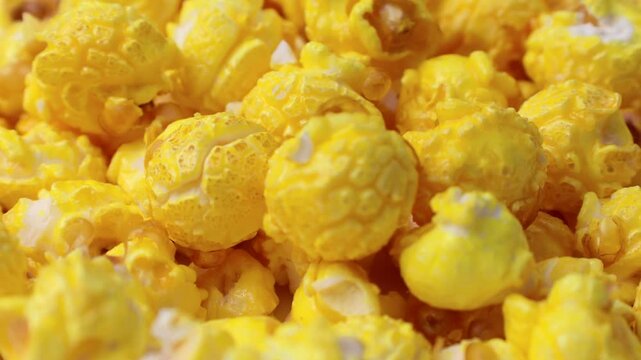 Yellow cheese popcorn falling down close up