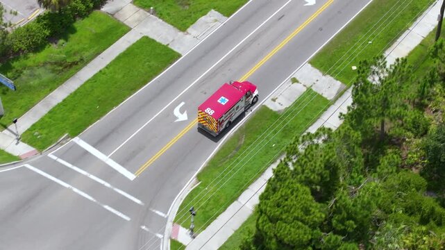 Fire rescue truck in motion on Florida road with emergency lights flashing, responding to active service call.