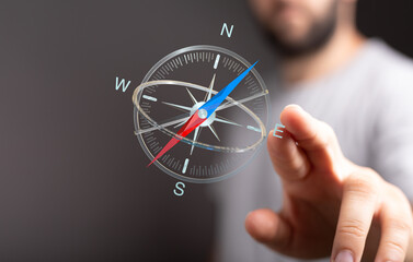 Close-up of a person interacting with a compass, representing decisions, guidance and goal setting for business and life