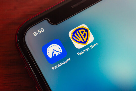 Quito, ECUADOR - Mar 2 2026 : Macro shot of iPhone home screen displaying Paramount and Warner Bros icons, symbolizing streaming entertainment, media brands, and movie industry today.