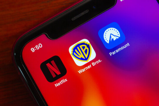 Quito, ECUADOR - Mar 2 2026 : Netflix, Warner Bros and Paramount icons are seen in an iPhone, highlighting streaming subscriptions, digital entertainment and media brands.