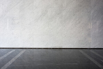 Fototapeta premium Gray white marble wall meeting dark gray tile floor with precise joint detail
