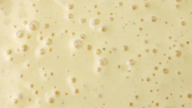 Active and bubbly sourdough starter batter for pancake circle rotation close up