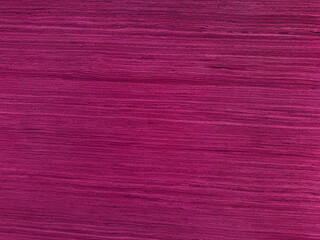 Vibrant magenta pink stained wood grain texture background. Horizontal lines on bright fuchsia wooden surface. Colorful timber plank pattern for creative design, banner, or backdrop. Modern pop art.