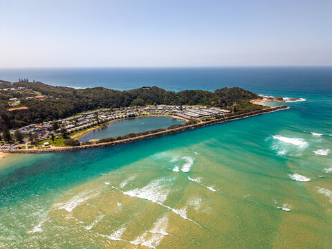 Aerial view of where the river meets the sea, creating a mesmerising swirl of turquoise and sandy hues, Nambucca Heads, New South Wales, Australia.