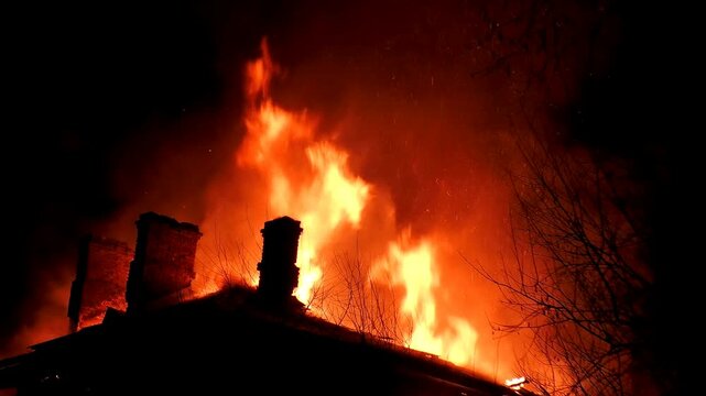The house is on fire, the nighttime flames of disaster. Natural wild flames burn houses.
