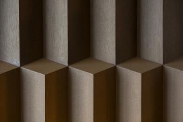 Naklejka premium Close-up of wooden geometric three-dimensional lattice structure with textured surfaces and shadow play