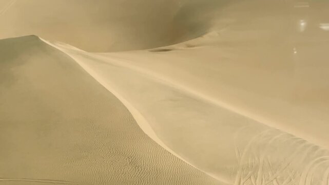 Sandwich Harbour in Namibia at the coast of the Atlantic Ocean. Sandy beach. Sandwich Harbor roundtrip daytime car tour