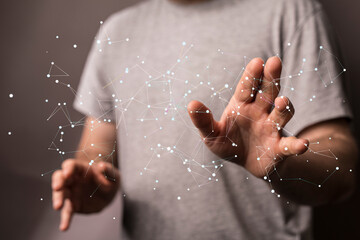 Close-up of a man's hand interacting with a network, showing connectivity, technology, and...