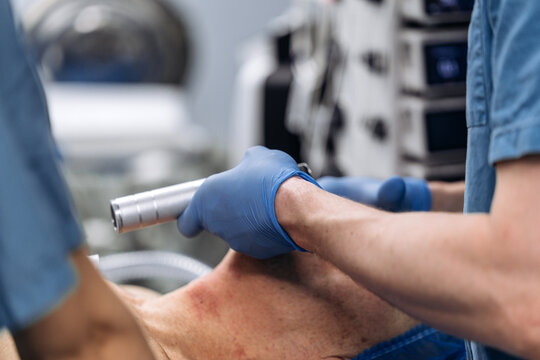An anesthesiologist performs precise endotracheal intubation of a patient. Concept of the clinical procedure.
