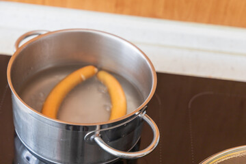 Boiling Sausages in Metal Pot on Electric Stove