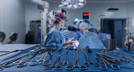 Hospital surgery with team of surgeons wearing sterile gowns and masks. Surgery concept.
