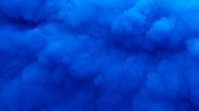 Surreal blue cloudscape forms and shifts creating dreamy atmosphere