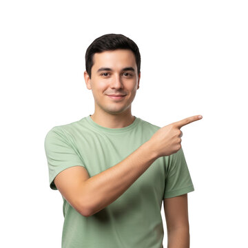 A man in a green t-shirt pointing to the side with a friendly smile isolated on transparent background
