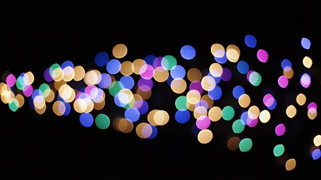 Abstract image of soft, blurred lights in various colors against a dark background