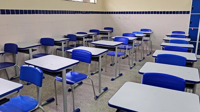 Empty classroom interior with rows of desks and school lockers