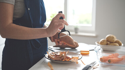Woman Cleaning Raw Sweet Potato