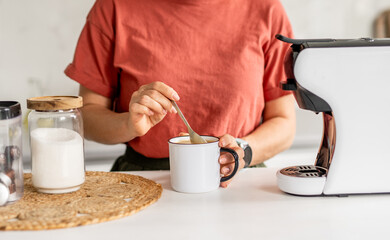 Woman Stirring Coffee In Cup