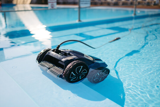 Robotic pool cleaner working underwater to keep swimming pool clean.