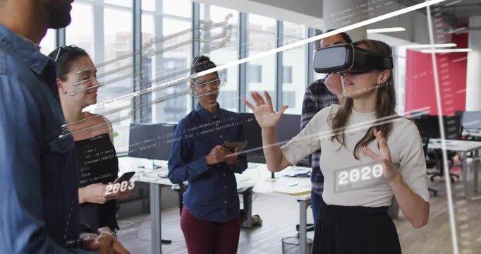 Woman wearing VR headset following colleague gesture in tech office, pinching year markers for demo