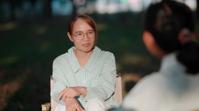 Two asian women having deep conversation in therapy session where mentor is teaching how to manage stress and encouraging self love for personal development and wellness lifestyle
