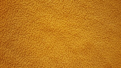 Warm yellow fleece fabric texture background, soft mustard textile material surface close-up, cozy fluffy carpet or blanket texture for design © عبد الحليم سراط