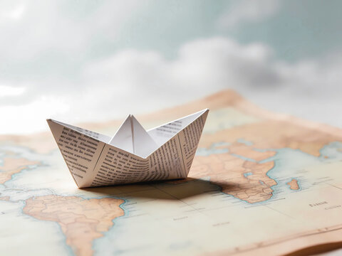 Paper Boat on World Map Representing Travel and Journey Concept. exploration, migration, global journey, and adventure planning.