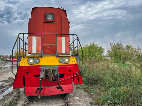A striking image capturing a vibrant red fire train positioned on the tracks. The dramatic sky serves as an incredible backdrop, enhancing the visual impact of this powerful scene.