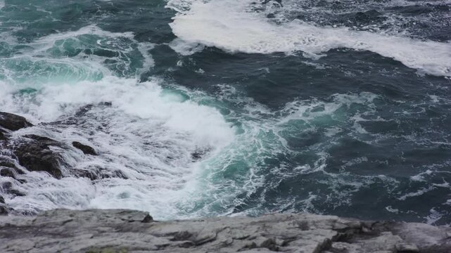Churning Atlantic Waters and White Sea Foam Along the Rugged Coast at Malin Head, Donegal, Ireland