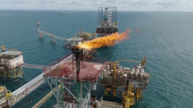 Offshore oil platform with gas flare at sea.  energy crisis and  need of Oil for the world. 