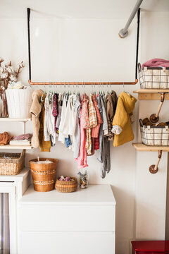Toddler clothes hanging in bedroom