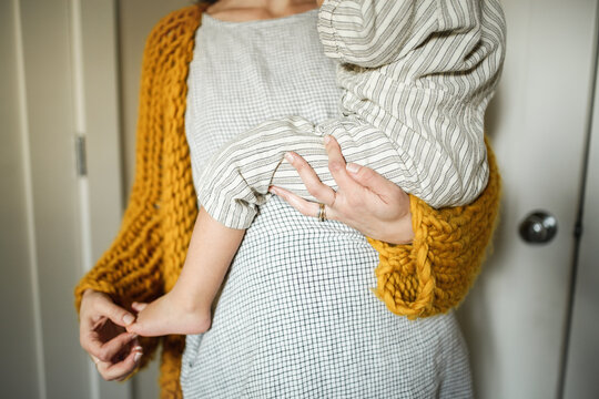 Pregnant Mother holding Toddler